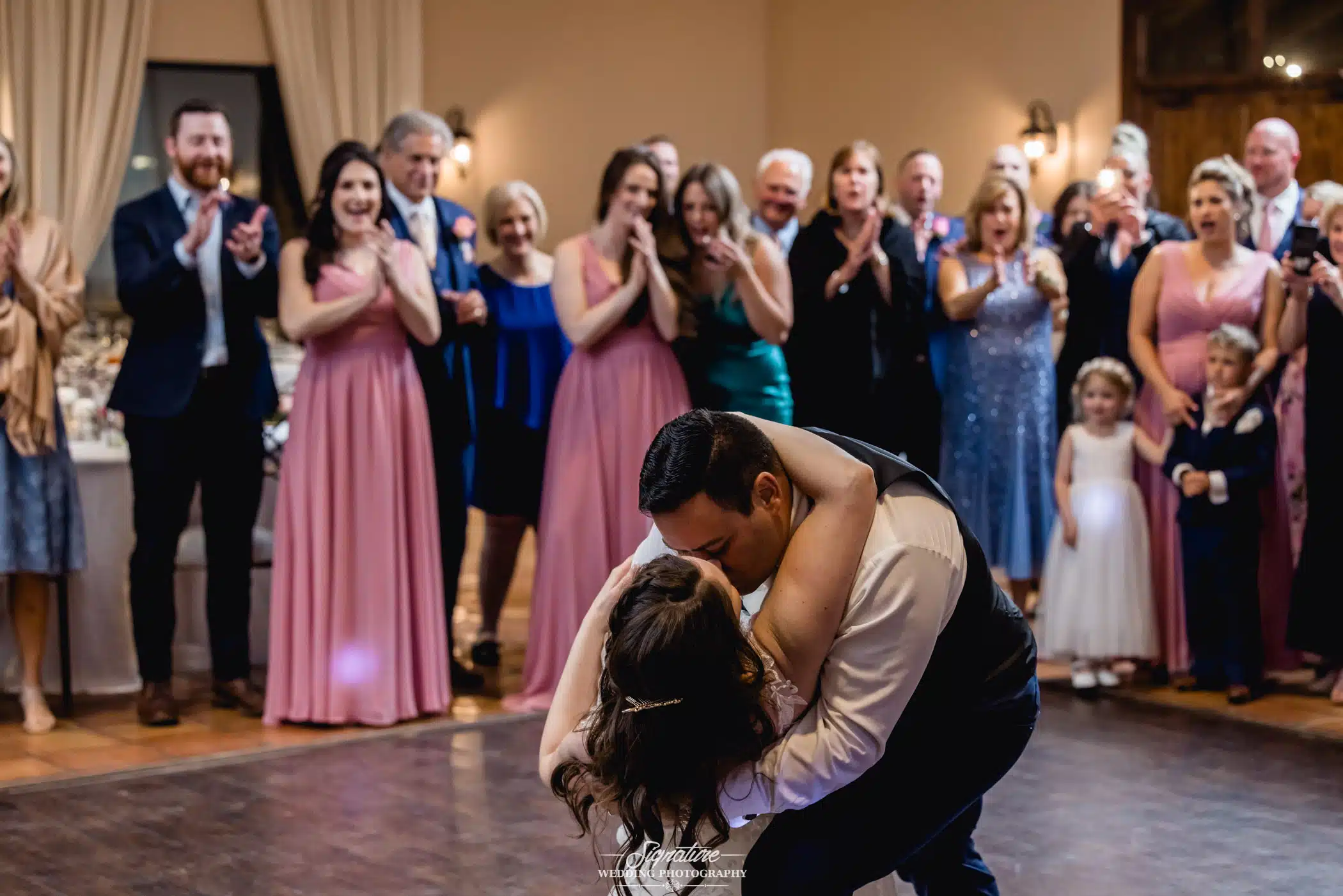 Image by Signature Wedding Photography Groom dipping bride during dance
