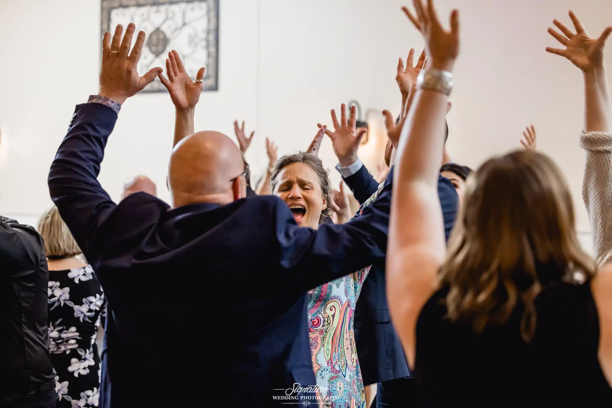 Image by Signature Wedding Photography Bride and groom dancing with wedding guests