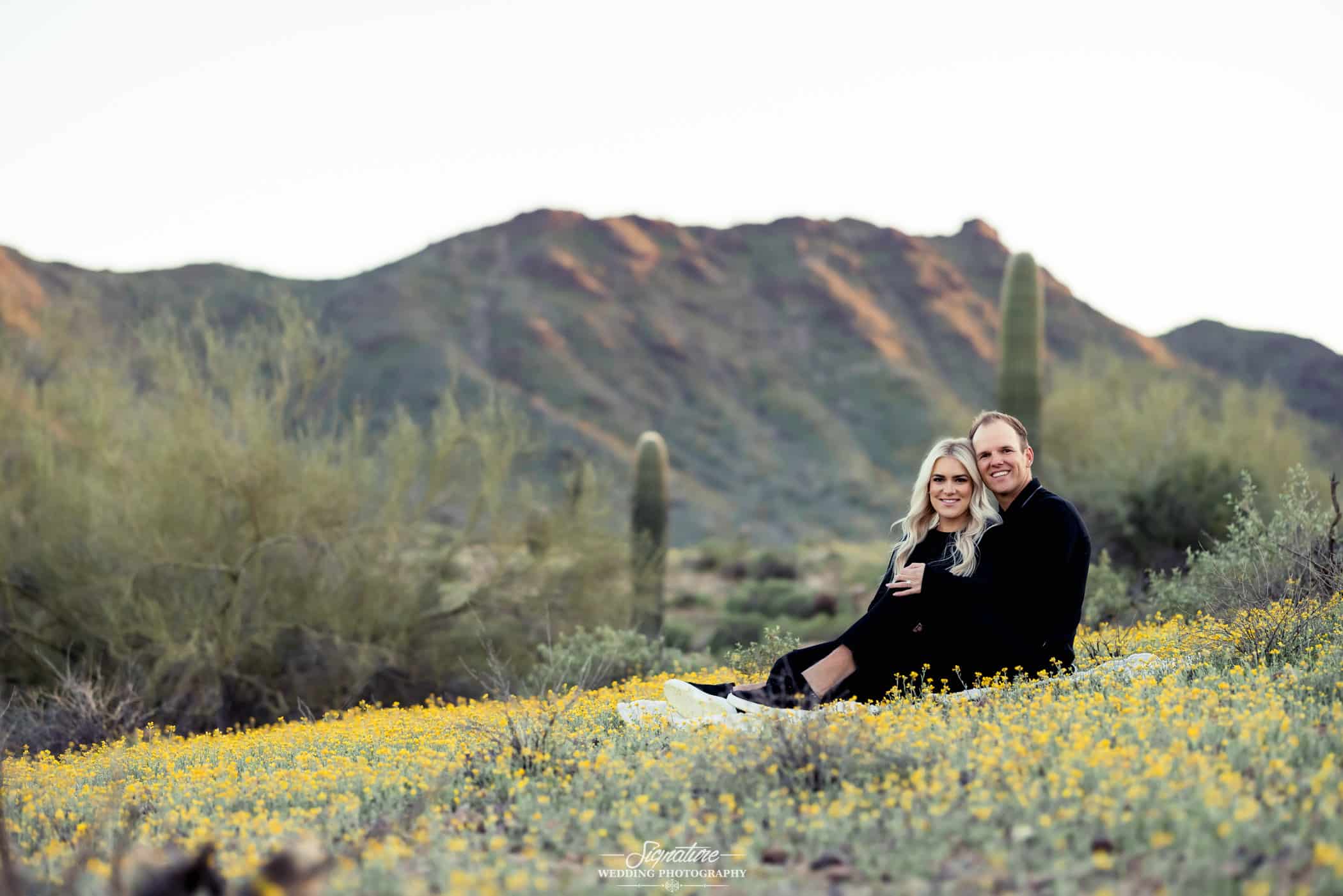 Sitting engagement photo in front of desert mountain