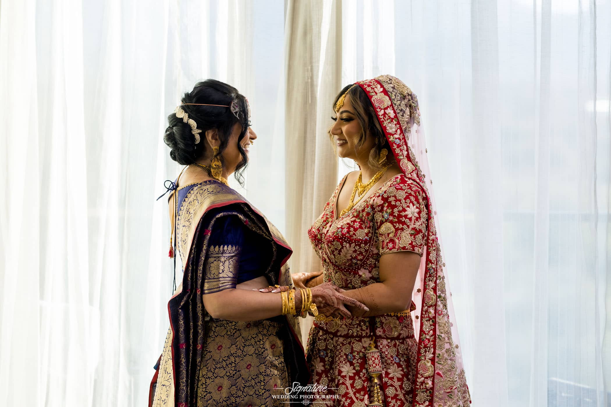 Bride and mother holding hands