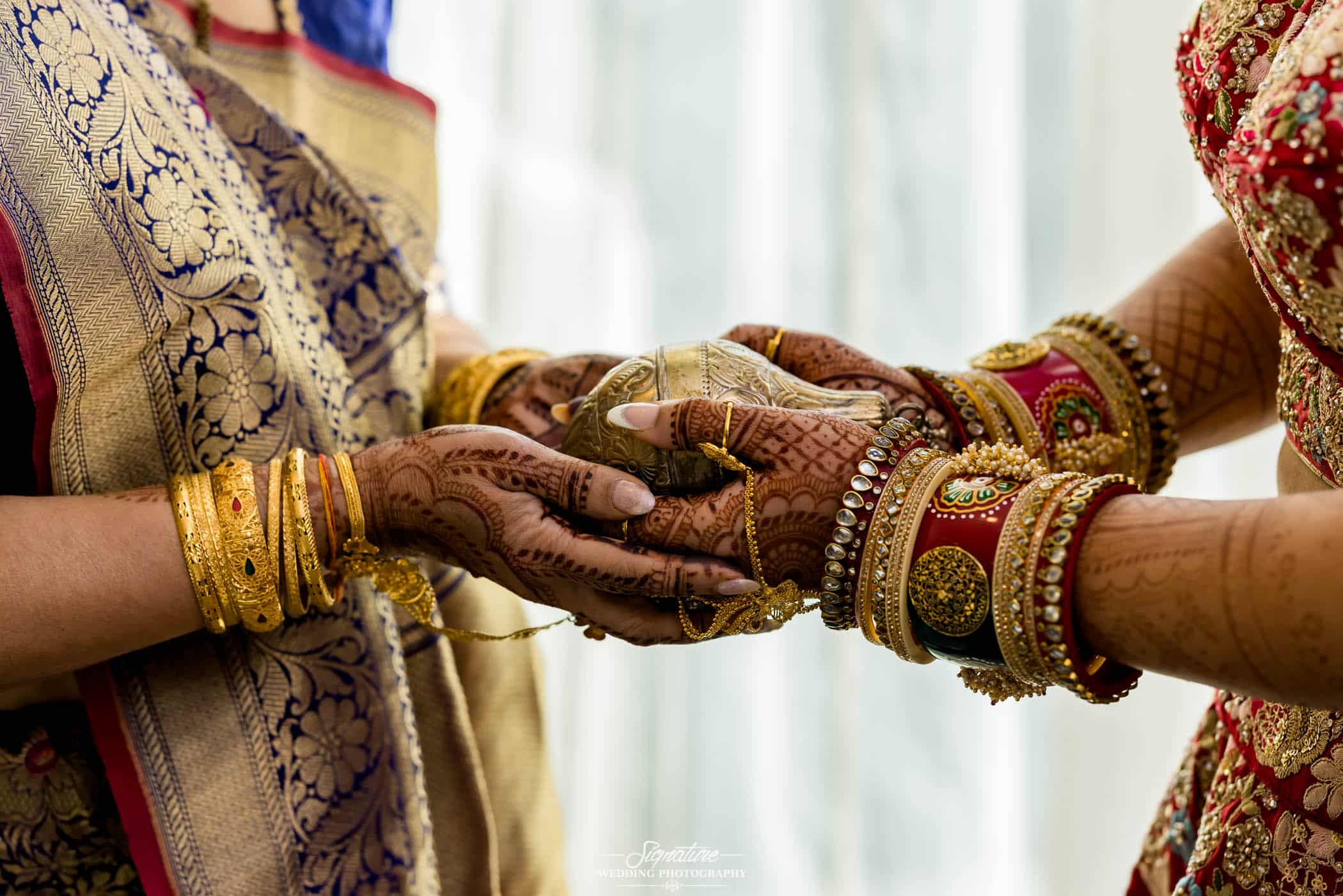 Bride and mother hold kumkum box