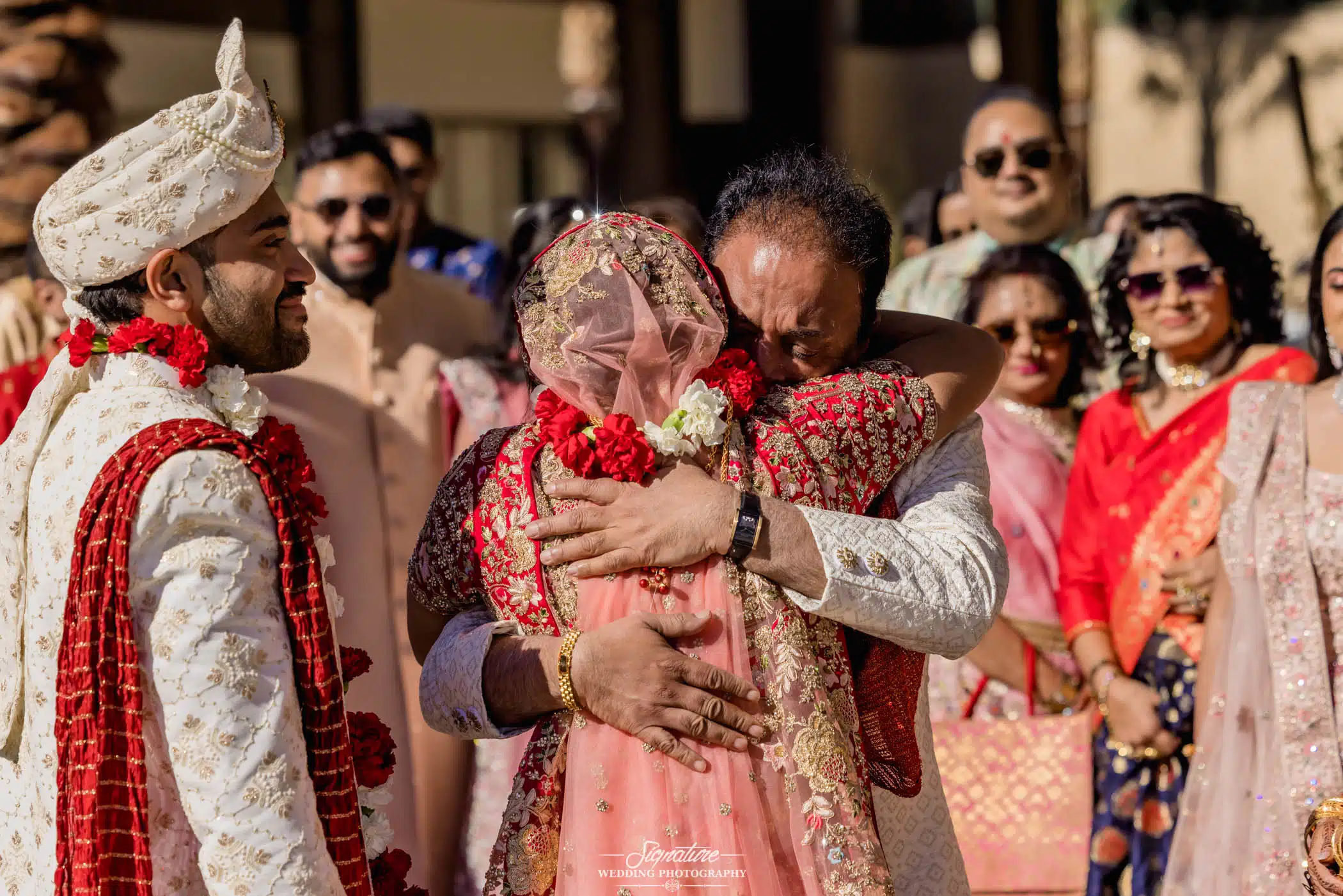 Image by Signature Wedding Photography Father hugging bride
