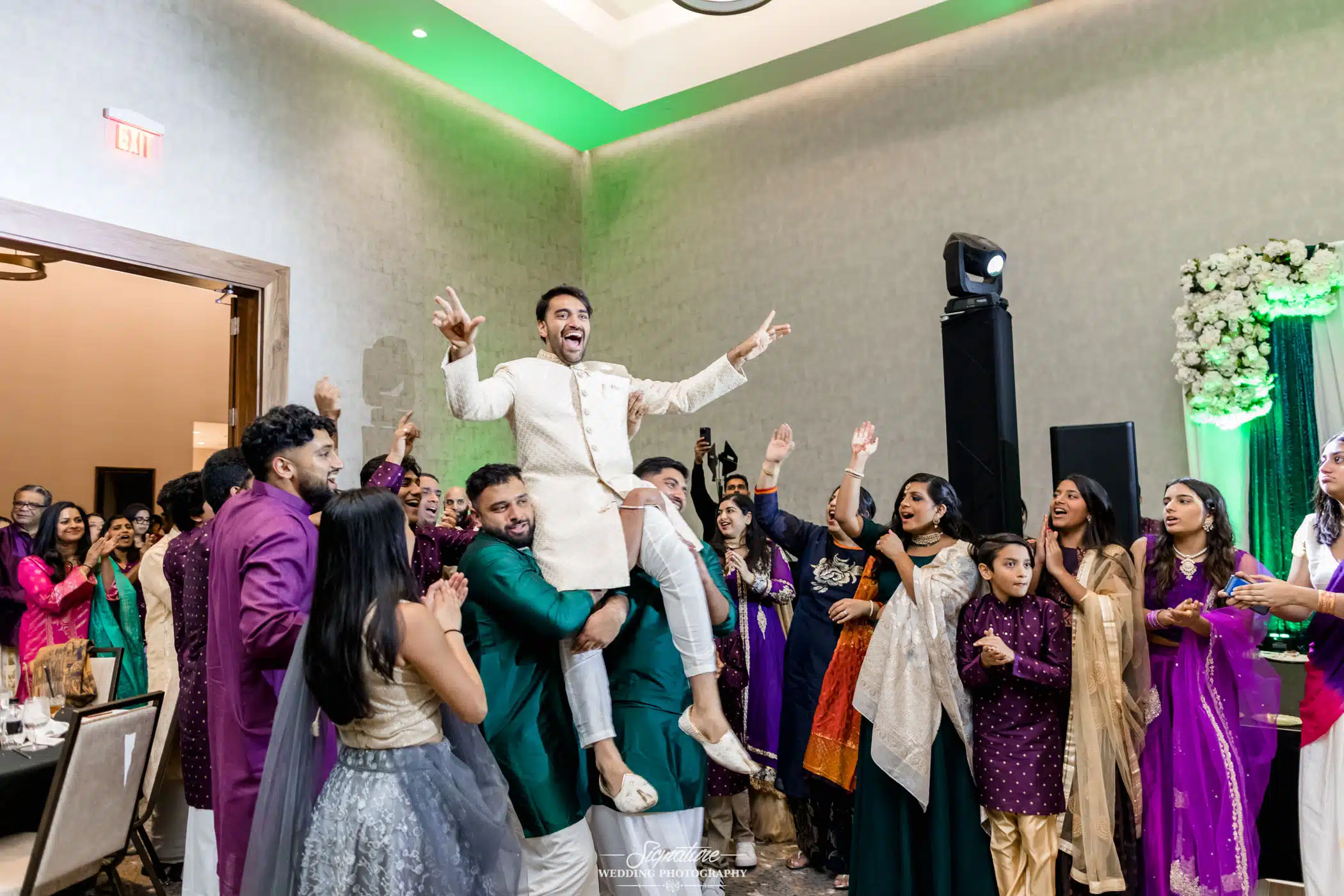Image by Signature Wedding Photography People picking groom up