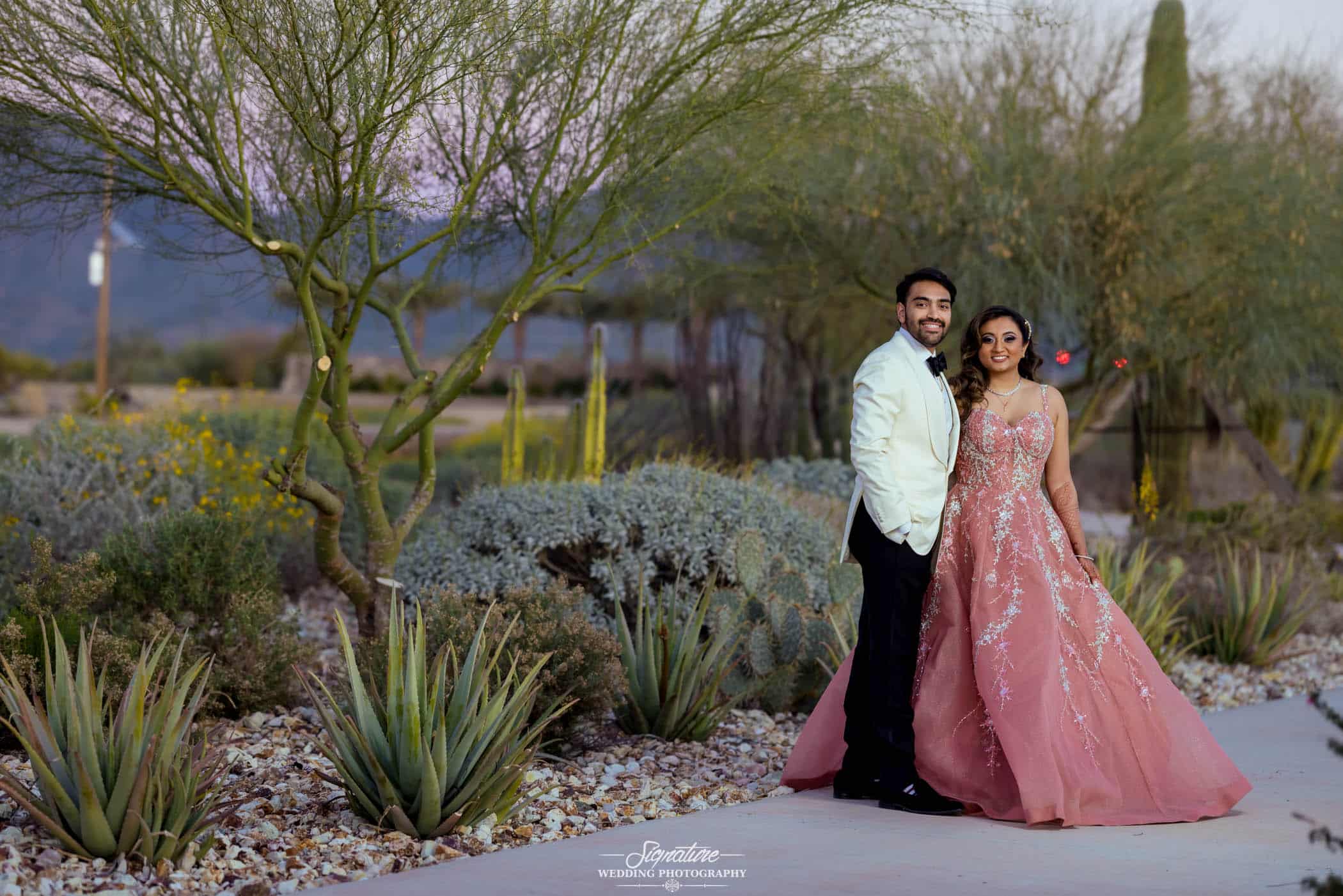 Bride and groom in front of desert plants