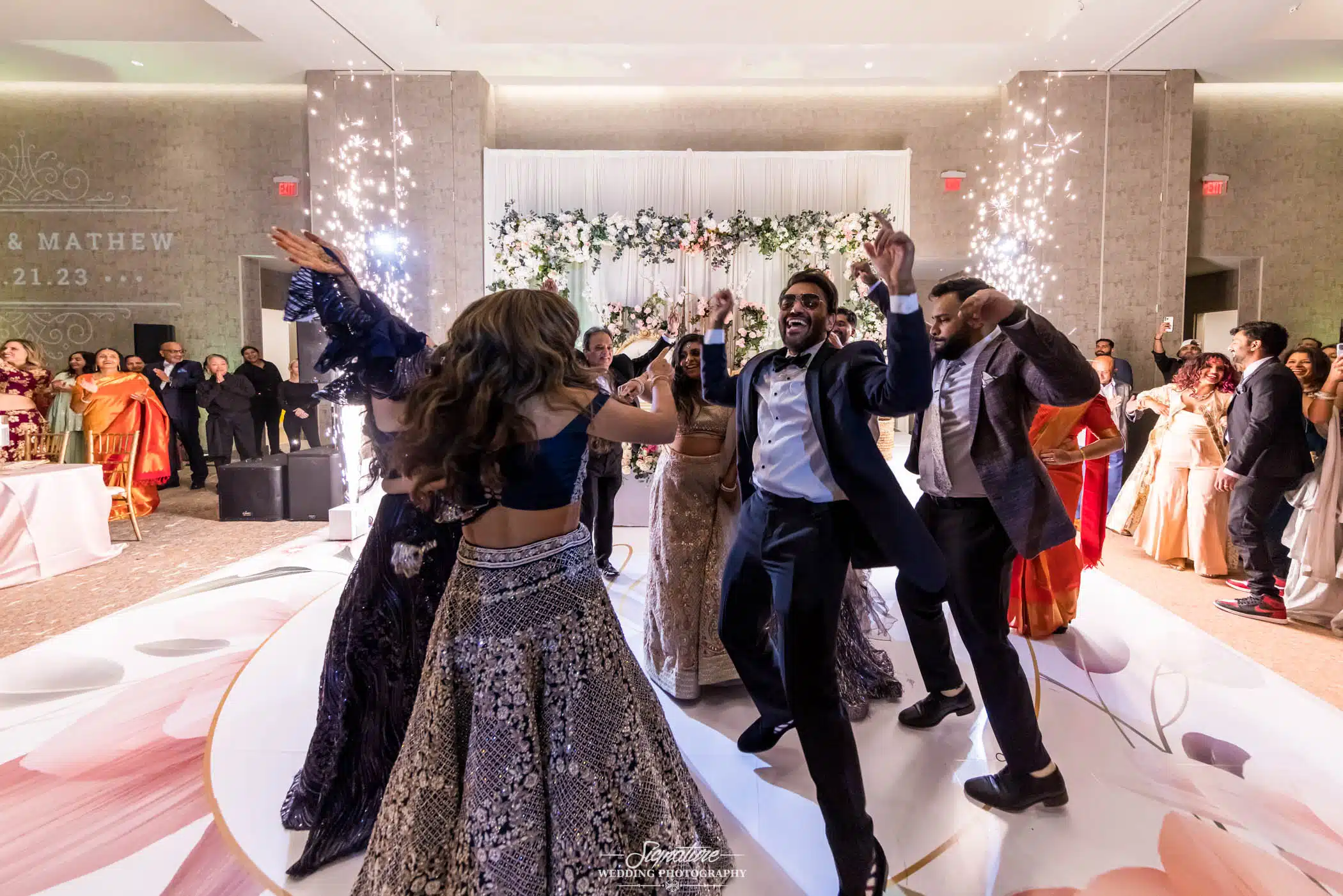 Image by Signature Wedding Photography Bride and groom dancing with wedding guests