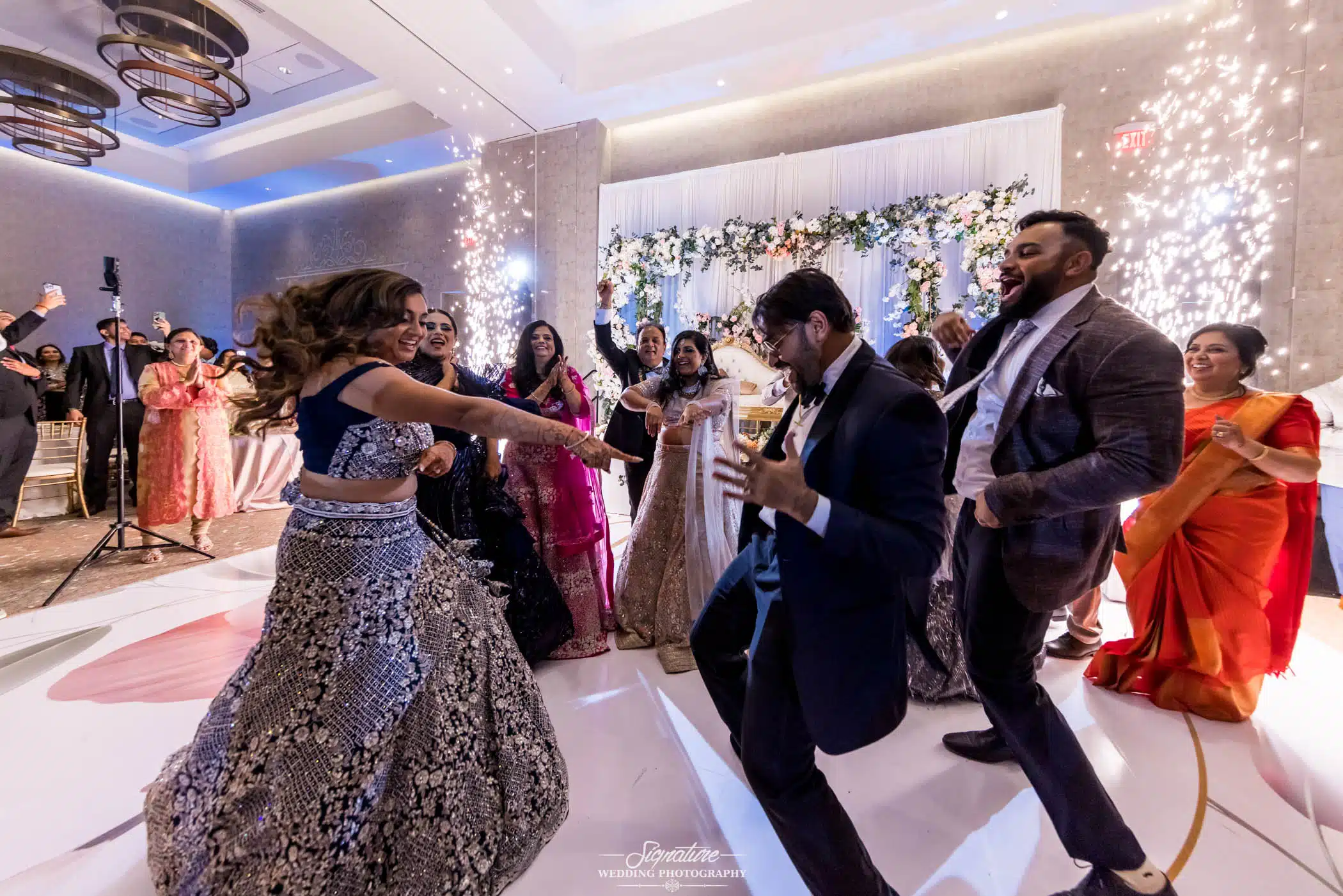 Image by Signature Wedding Photography Bride and groom dancing with wedding guests