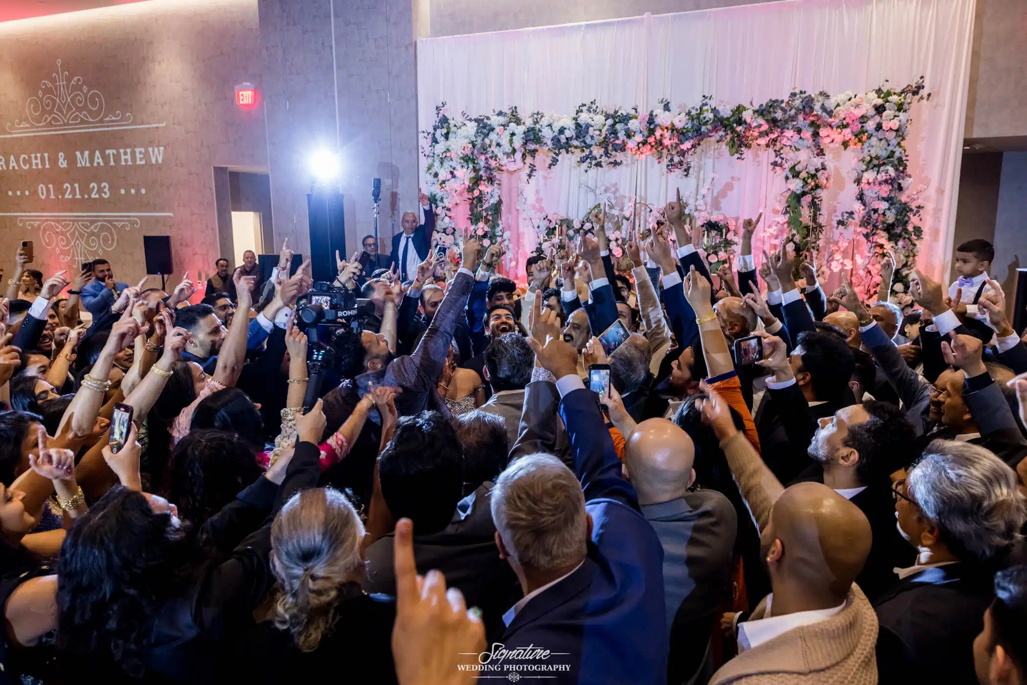 Image by Signature Wedding Photography Bride and groom dancing with wedding guests