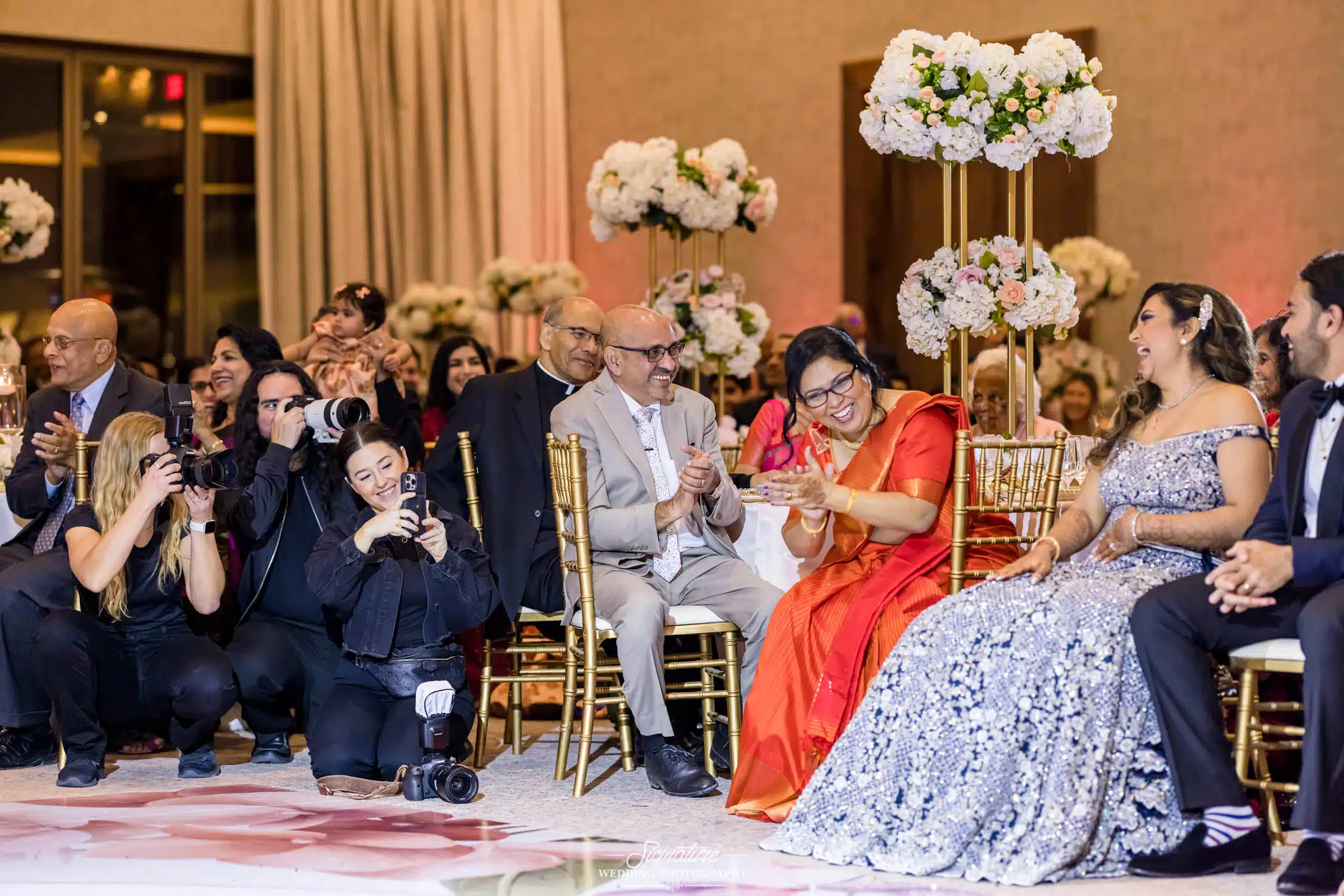 Image by Signature Wedding Photography Wedding guests smiling during reception