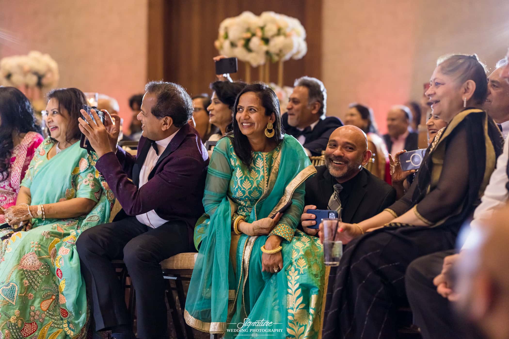 Wedding guests smiling during reception