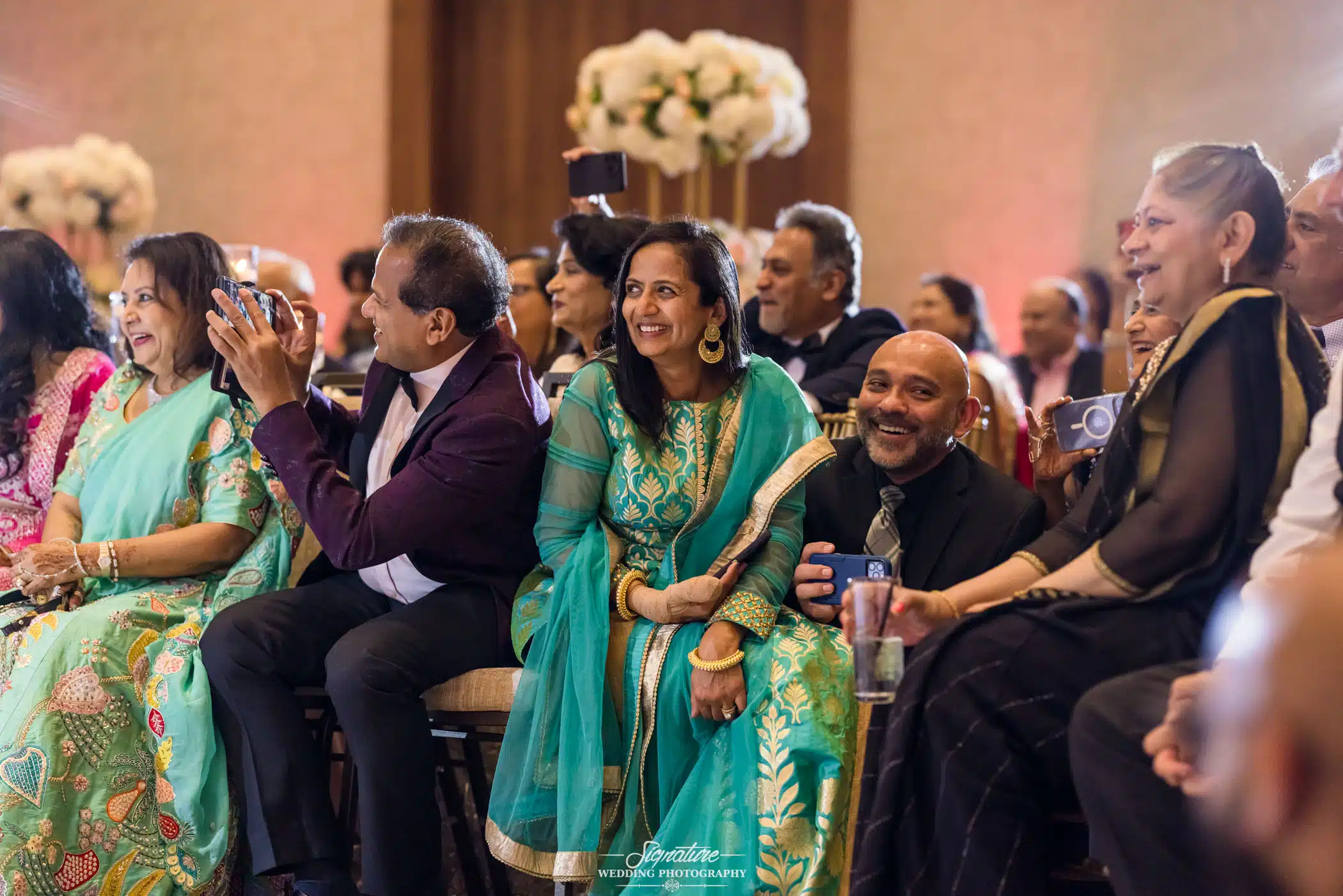 Image by Signature Wedding Photography Wedding guests smiling during reception