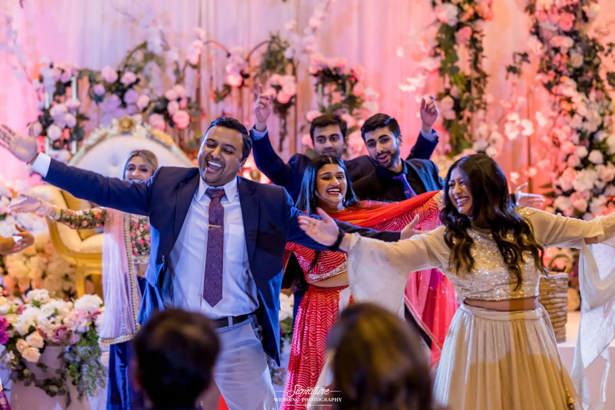 Image by Signature Wedding Photography Wedding guests dancing for bride and groom
