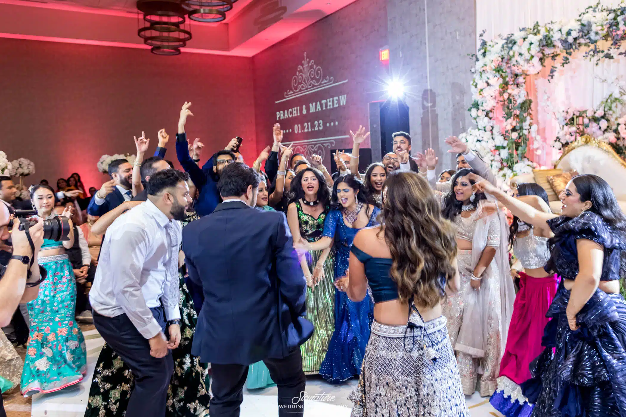 Image by Signature Wedding Photography Bride and groom dancing with wedding guests