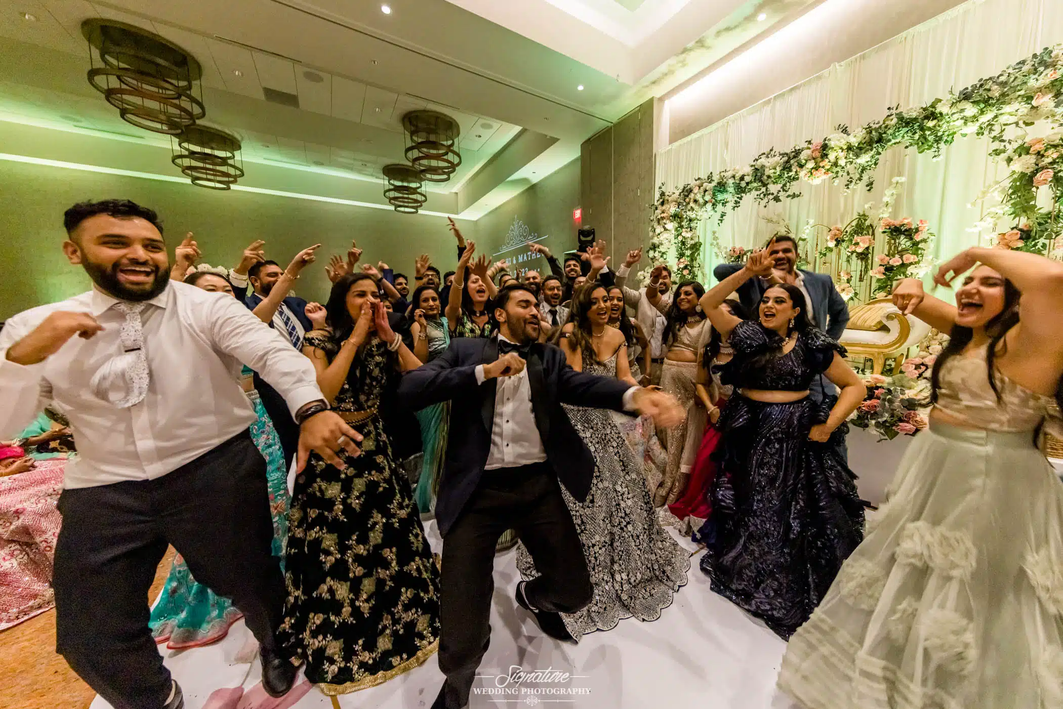 Image by Signature Wedding Photography Bride and groom dancing with wedding guests