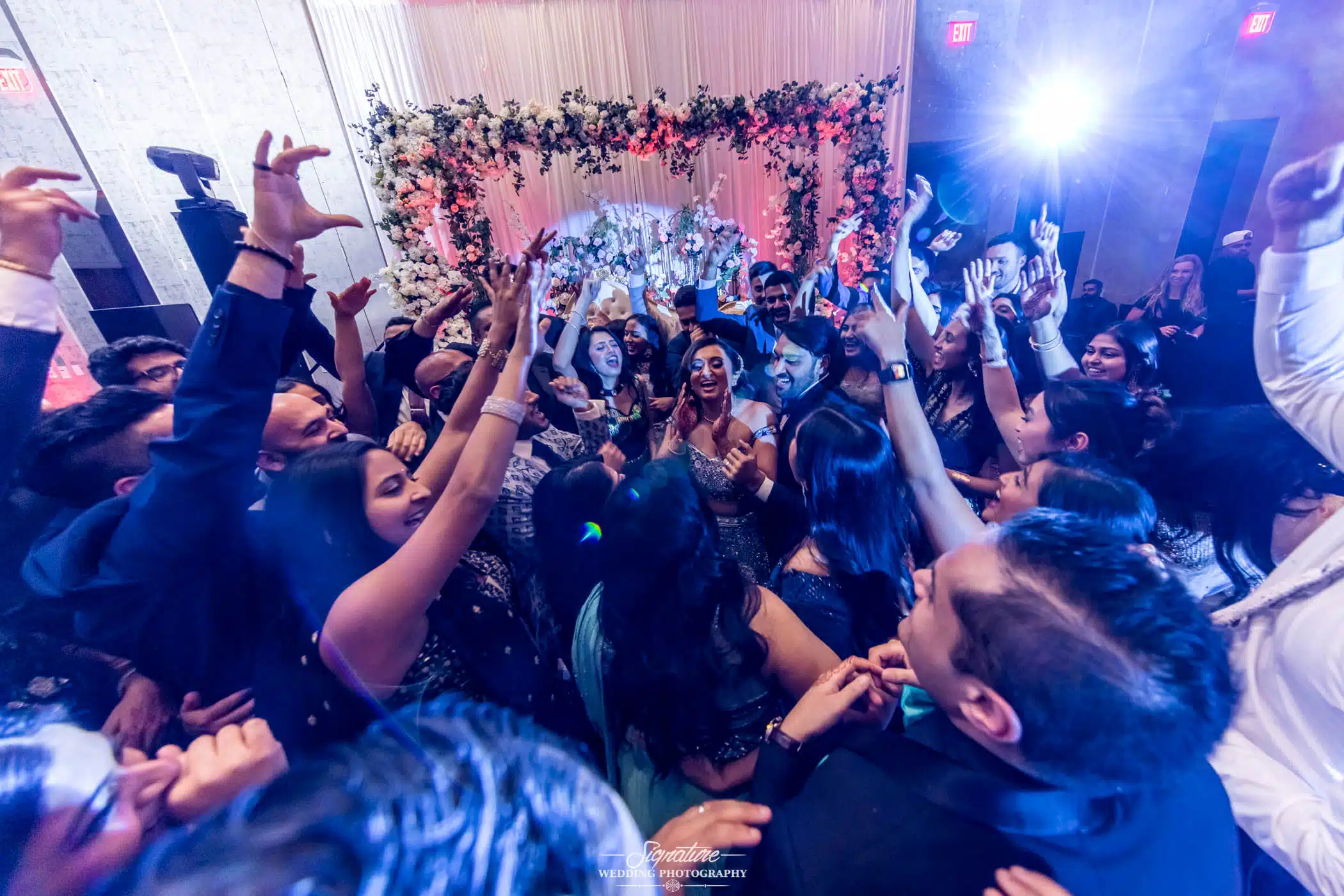 Image by Signature Wedding Photography Bride and groom in the middle of wedding guest circle