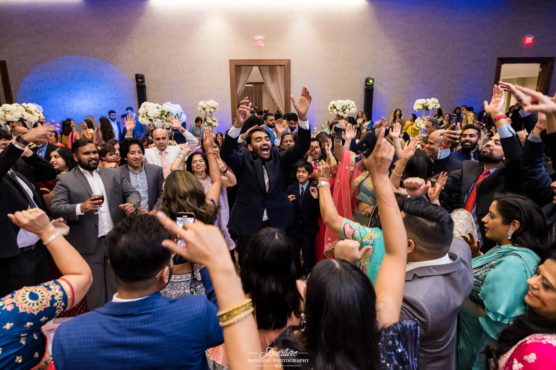 Image by Signature Wedding Photography Groom dancing with wedding guests