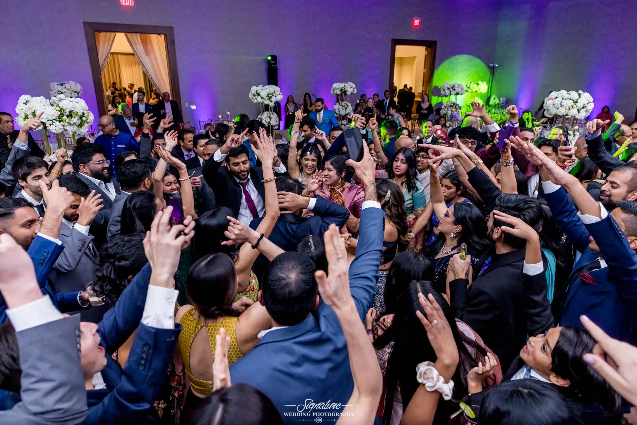 Image by Signature Wedding Photography Wedding guests dancing in circle