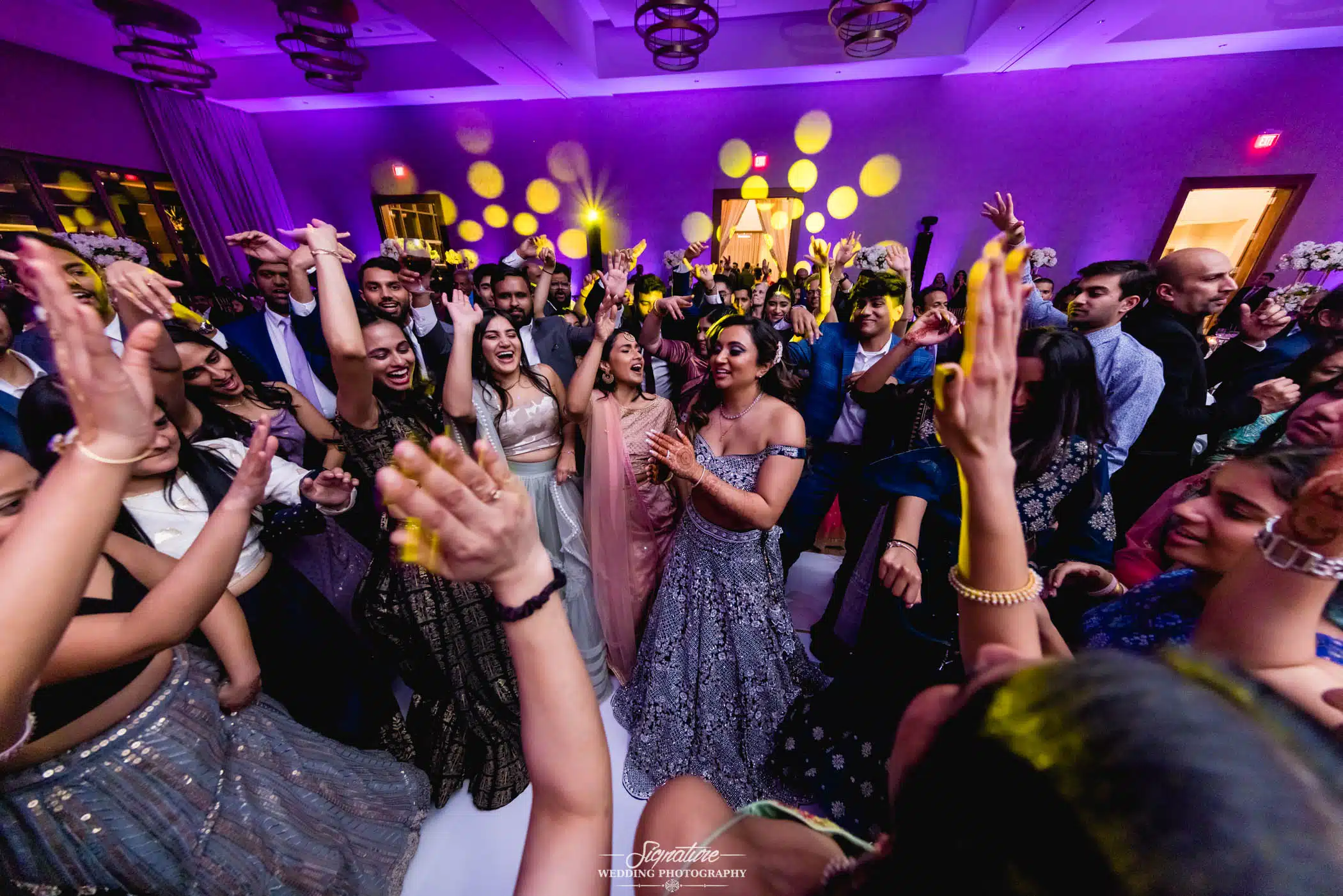 Image by Signature Wedding Photography Wedding guests dancing in circle
