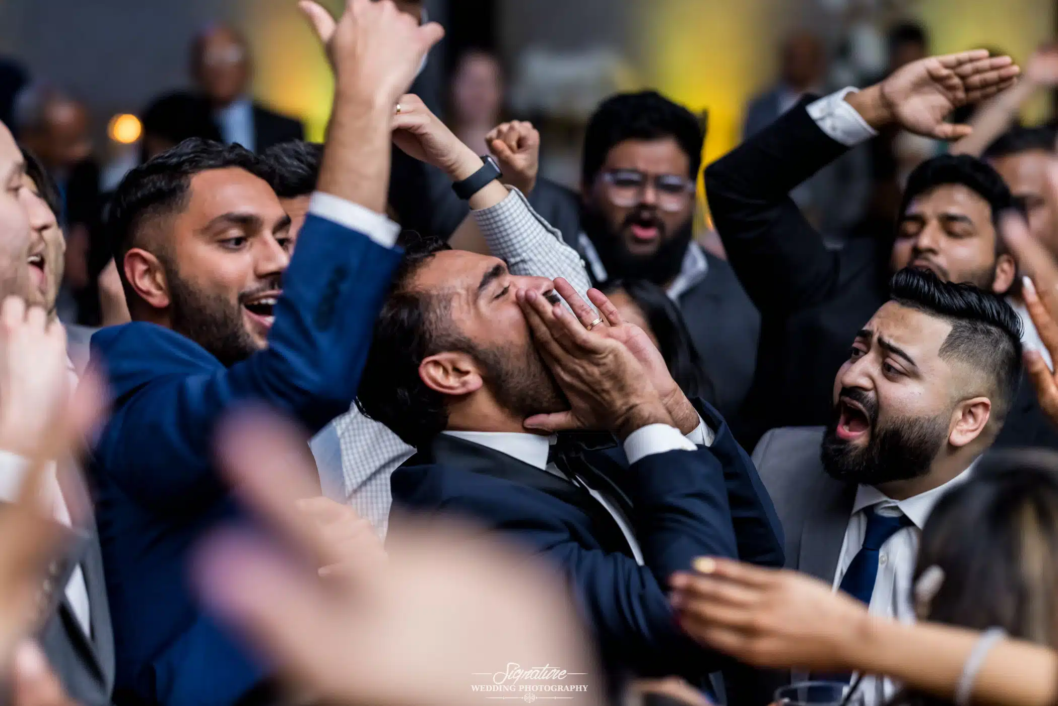 Image by Signature Wedding Photography Wedding guests dancing and shouting