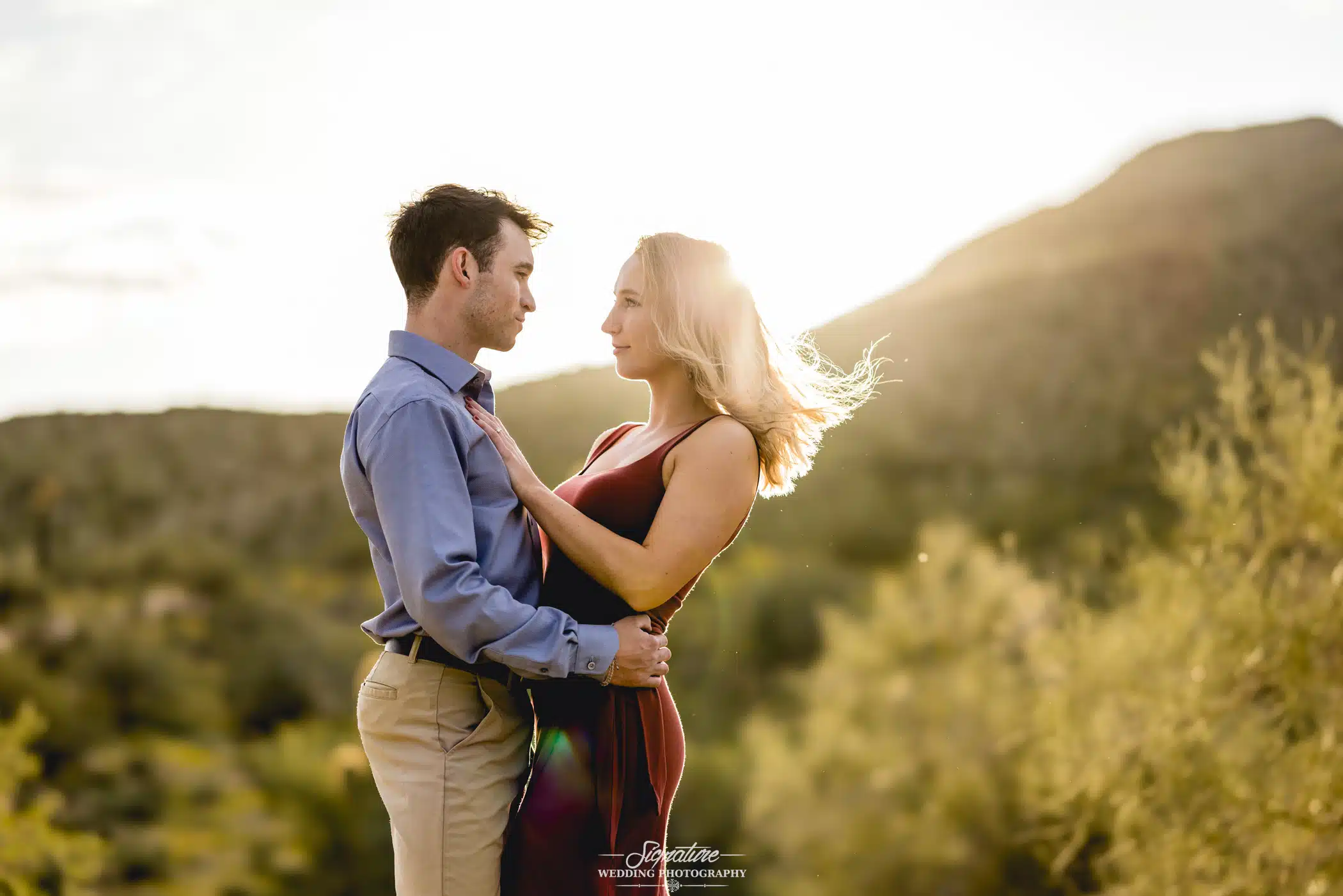 Image by Signature Wedding Photography Couple hugging at sunset