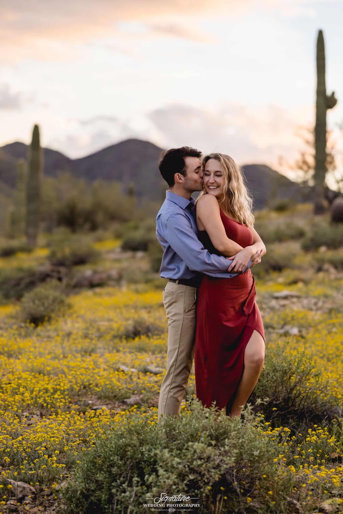 Man hugging woman in desert