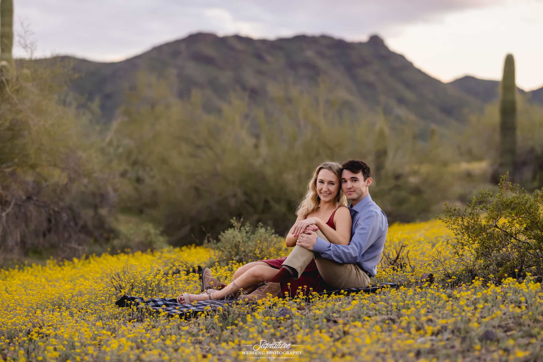 Sitting engagement photo in front of desert mountain