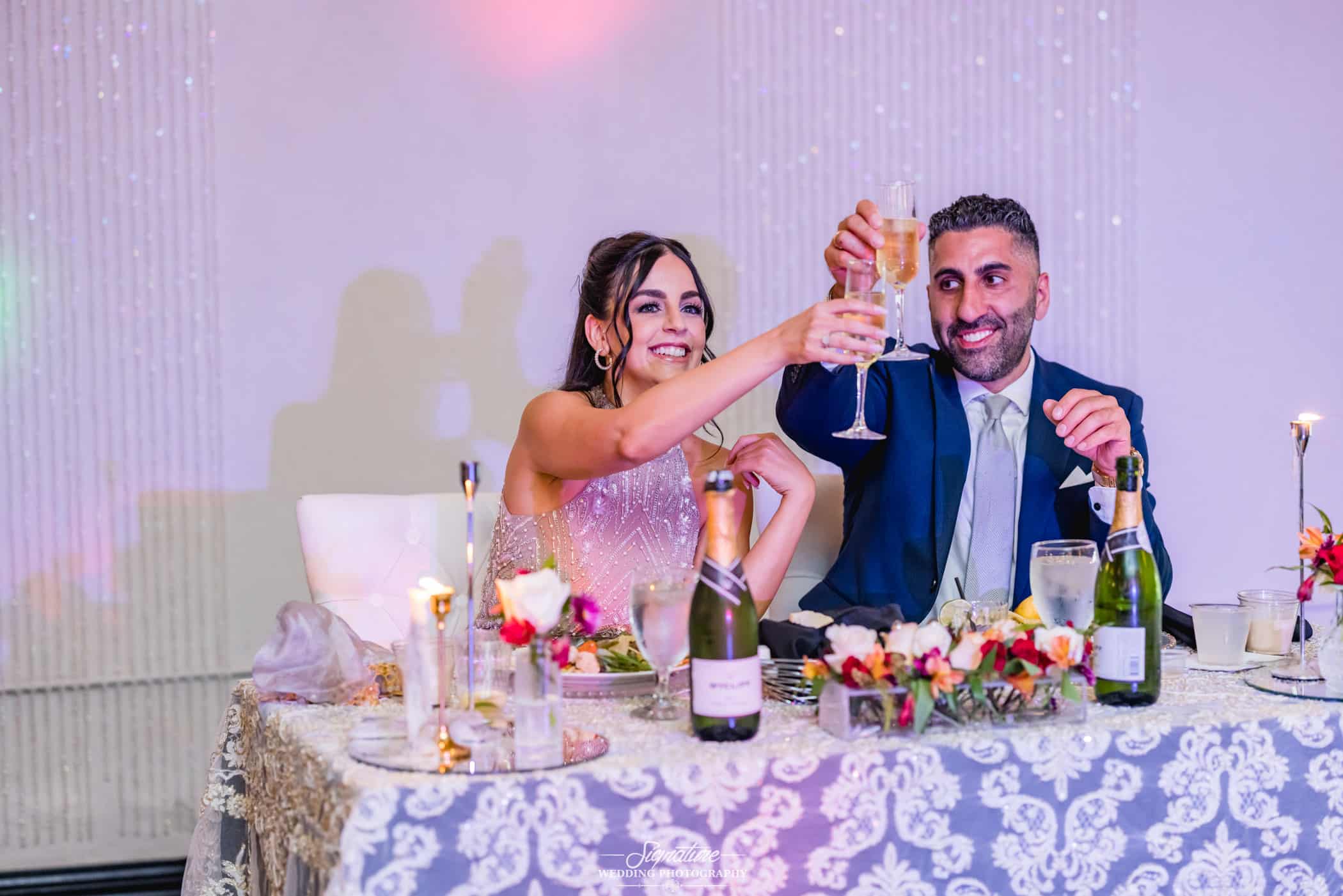 bride and groom making a toast at their wedding reception