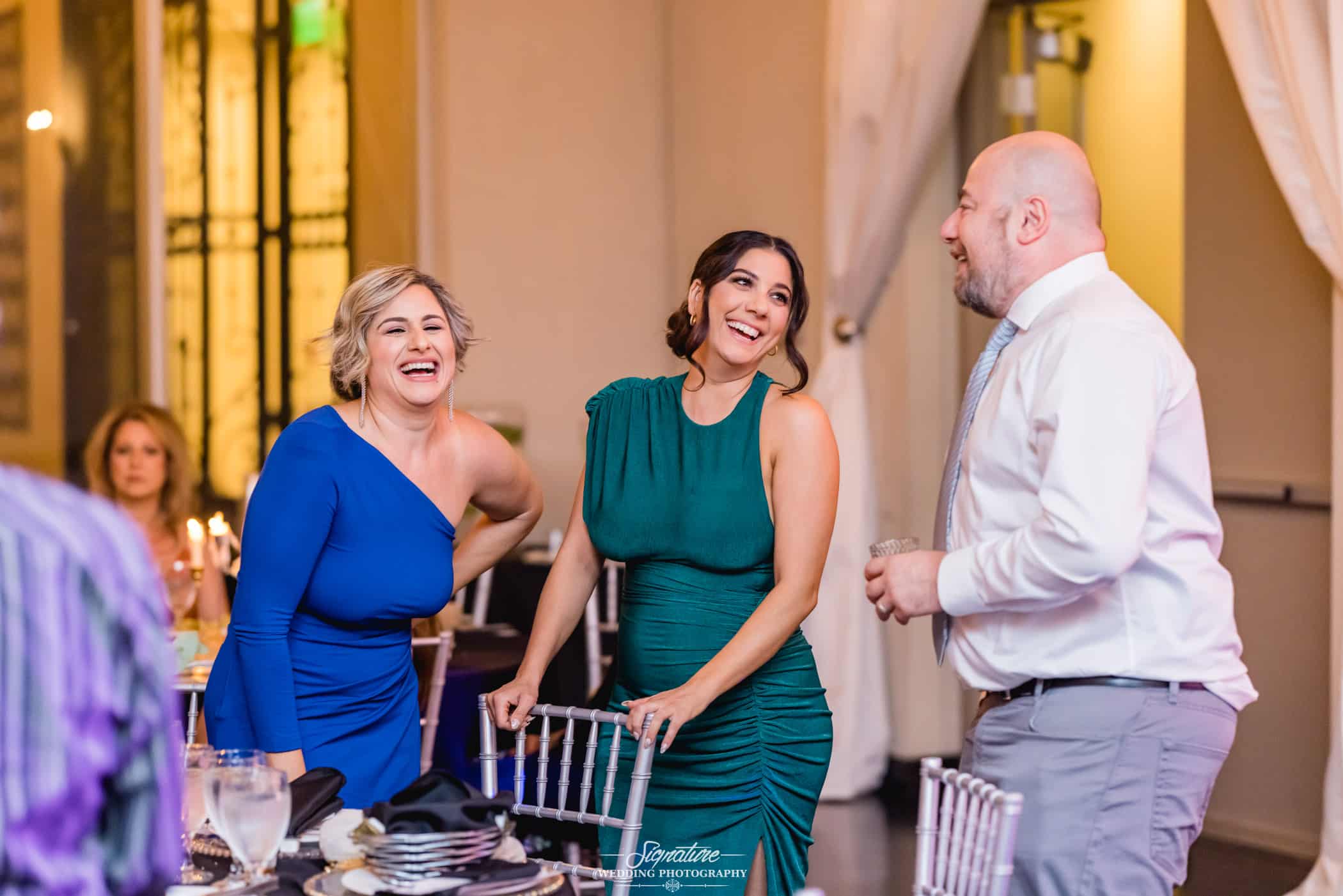 guests laughing at a wedding reception