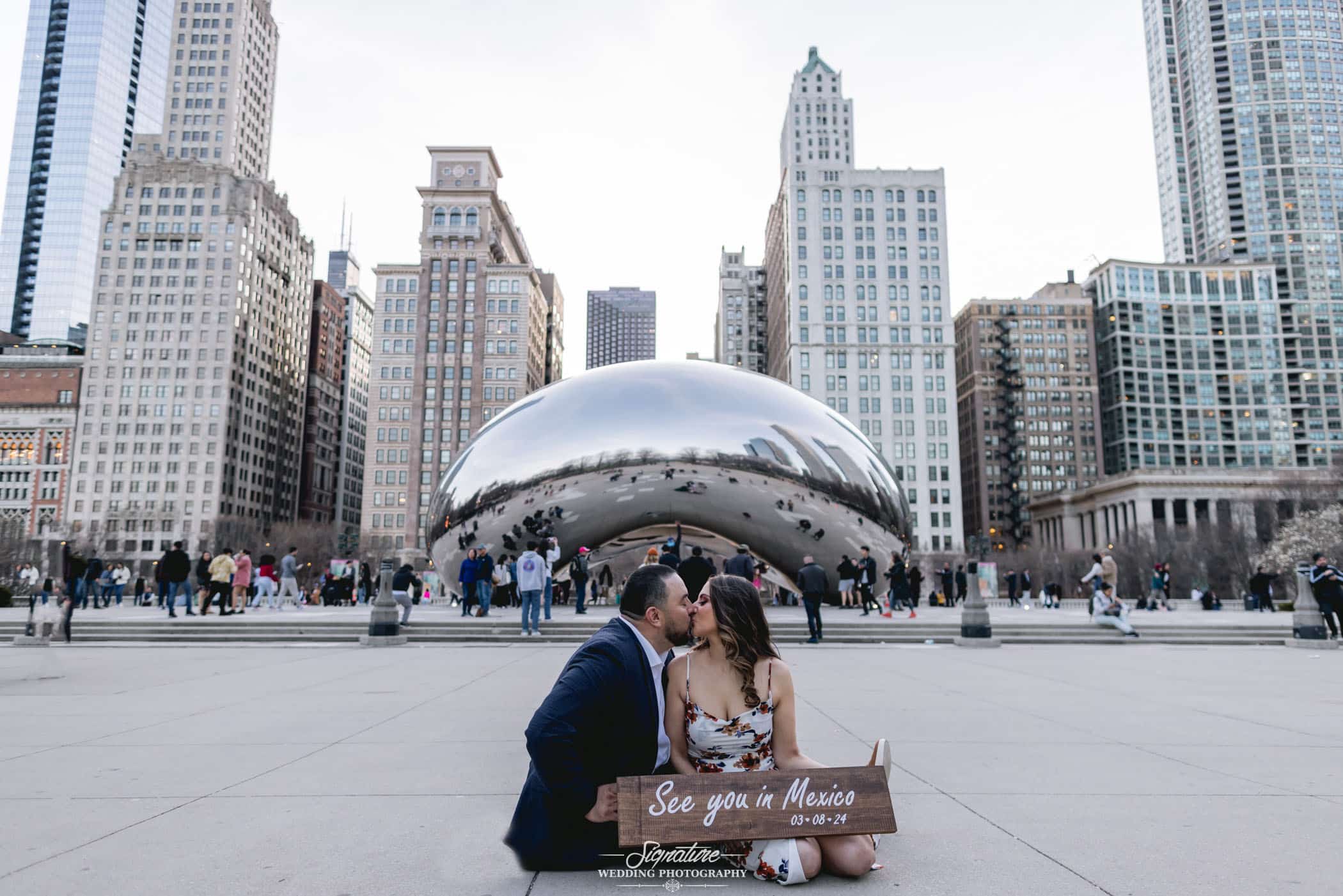 engagement photo of couple with the bean in the background