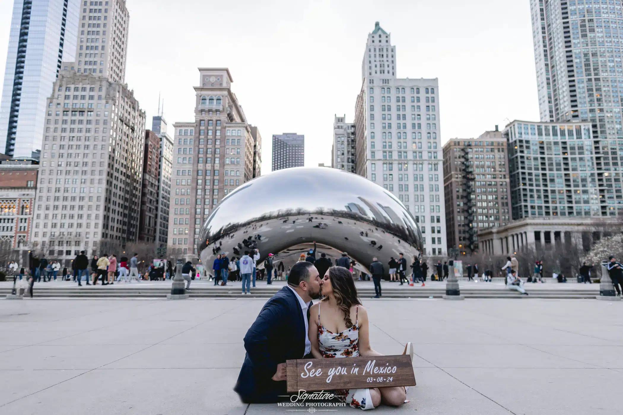 Image by Signature Wedding Photography engagement photo of couple with the bean in the background