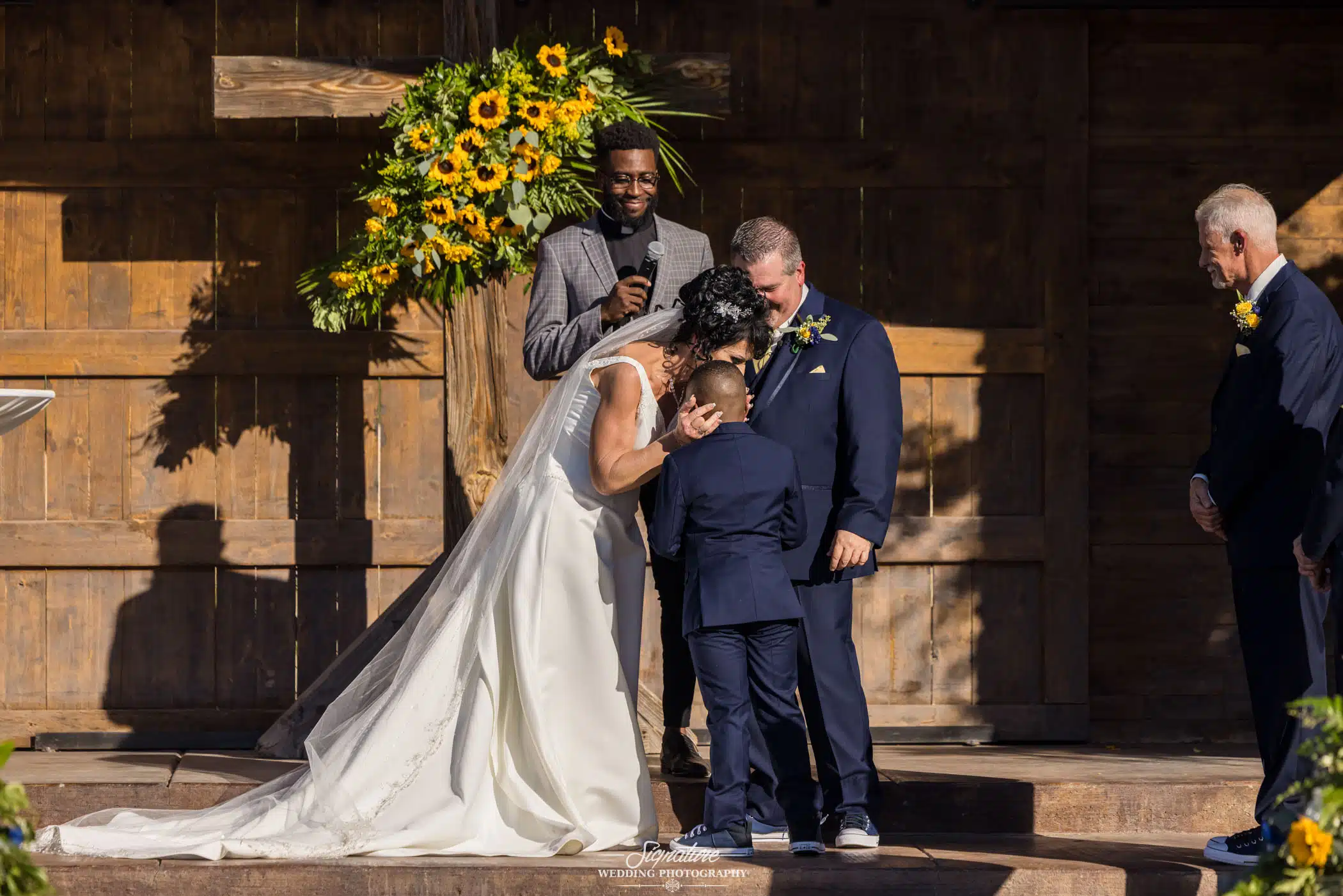 Image by Signature Wedding Photography bride hugging the ring bearer