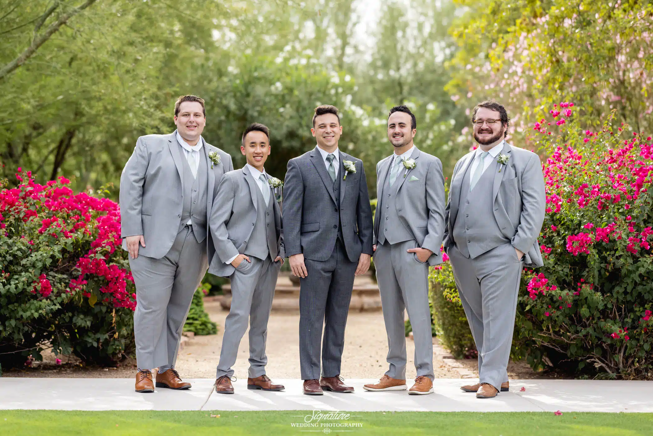 Image by Signature Wedding Photography groom and groomsmen smiling outside