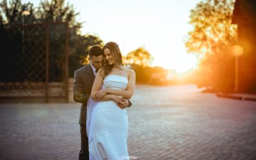 Image by Signature Wedding Photography groom hugging his bride with the sunset in the background