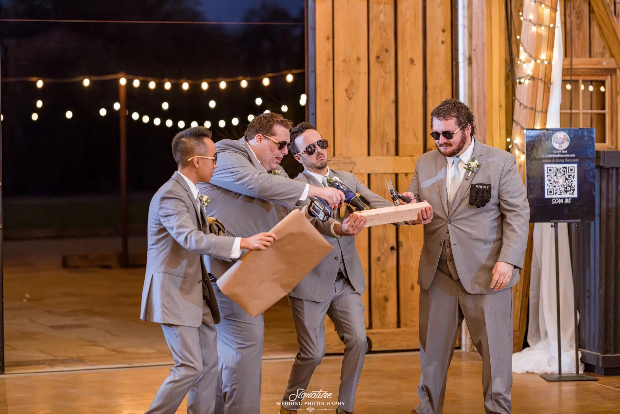 Image by Signature Wedding Photography groomsmen doing a prank at the wedding reception