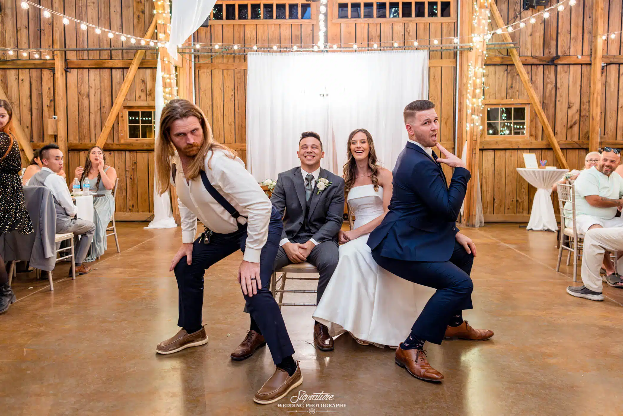 Image by Signature Wedding Photography candid group shot of bride and groom with friends