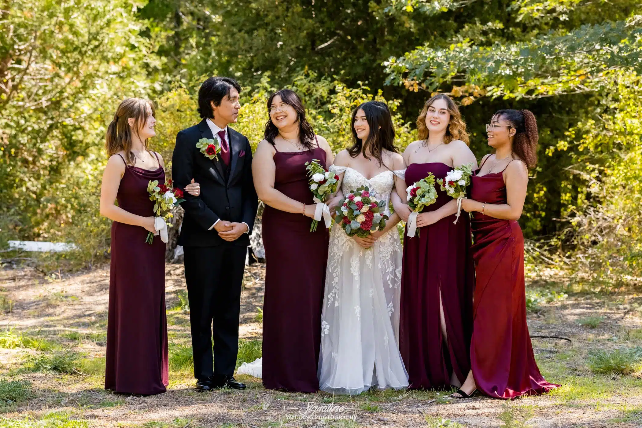 Image by Signature Wedding Photography candid group shot of various wedding party members