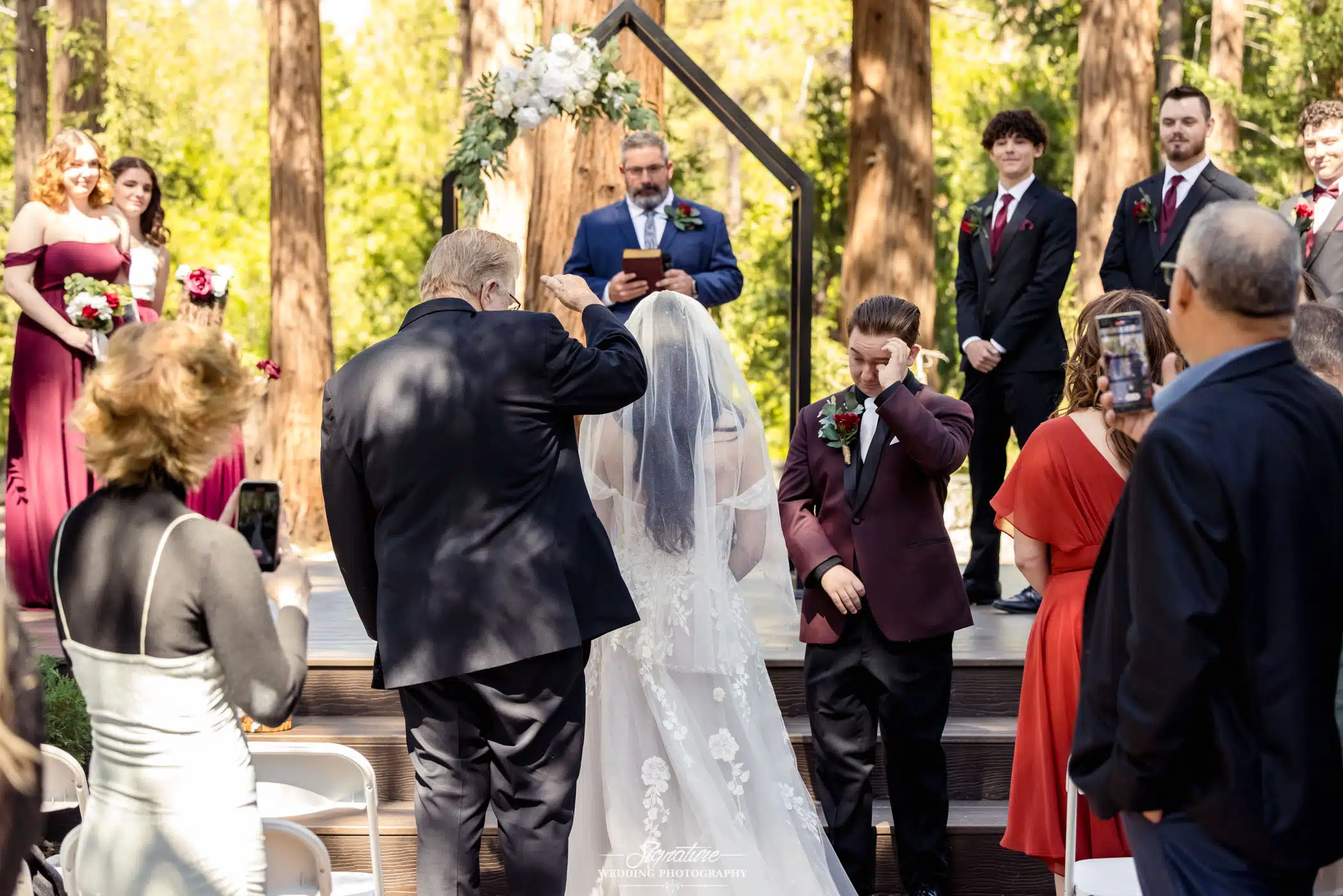 Image by Signature Wedding Photography emotional groom as bride reaches him at the end of the aisle