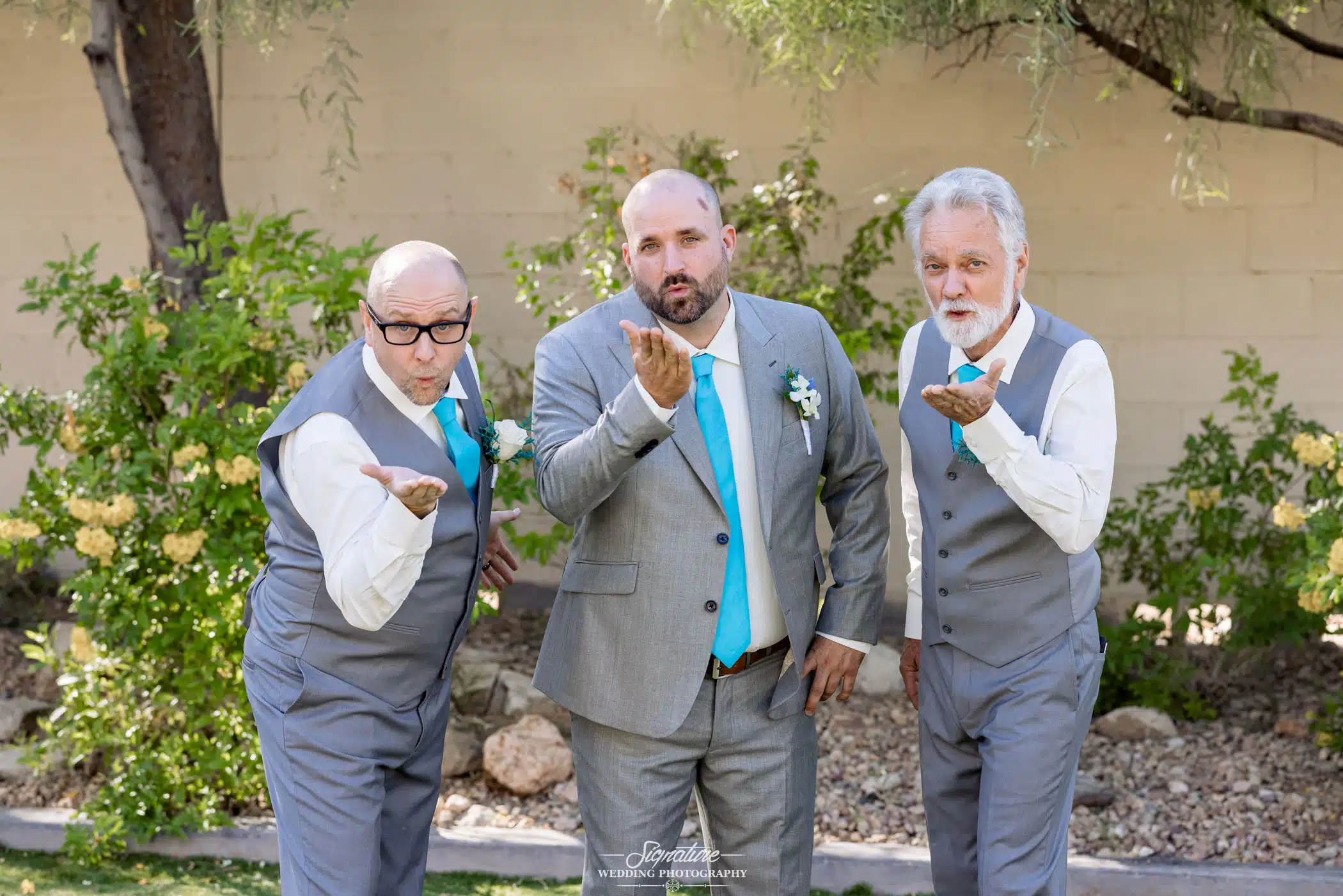 Image by Signature Wedding Photography a groom and two of his groomsmen blowing a kiss to the camera