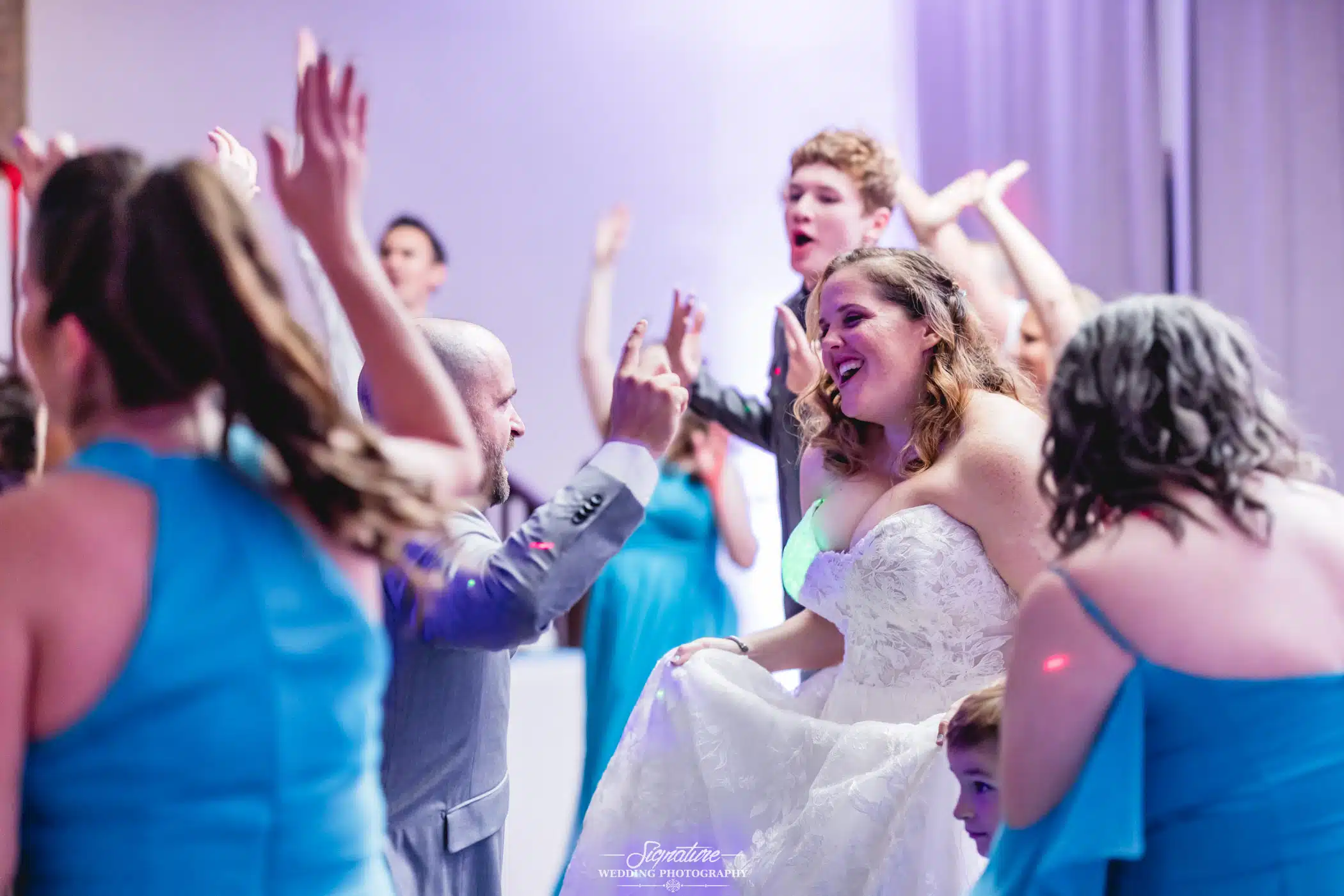 Image by Signature Wedding Photography happy bride and groom dancing at their wedding reception